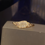 Radiant cut ring pear side stones