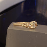 Radiant cut ring pear side stones